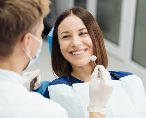 male-professional-dentist-with-gloves-mask-discuss-what-treatment-will-look-like-patient-s-teeth